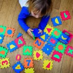 child plays with letter blocks