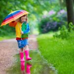 child holding umbrella