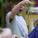 child engaged in messy play