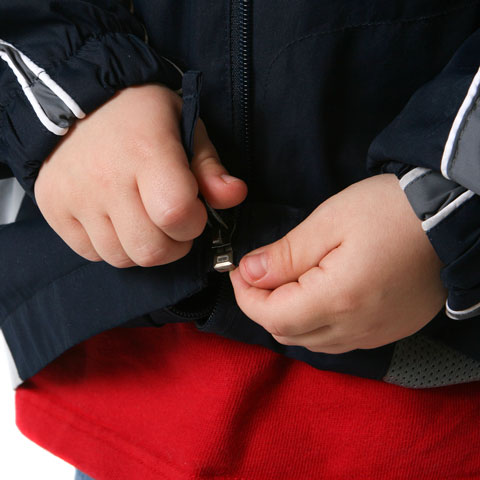 child zipping coat