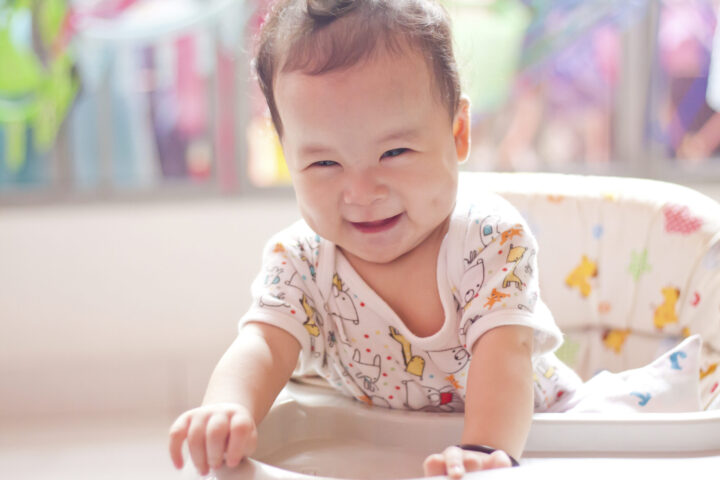 smiling baby in high chair